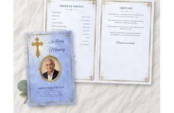 Bright Golden Cross bifold funeral program mockup on linen: the periwinkle blue cover, with a photo of a smiling older man in a beaded gold oval frame under a gold filigree cross, beside the open inside spread.